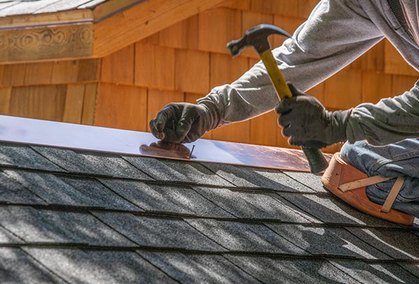Roofing Contractors Perform Work On Roofs